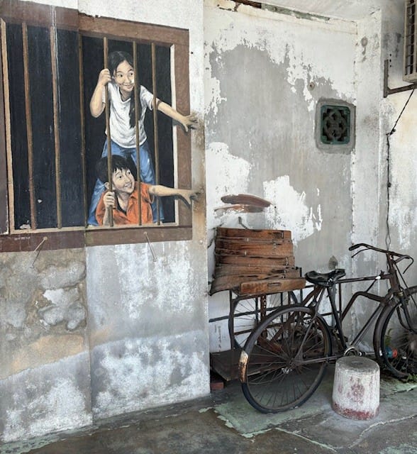 Children behind window bar mural George Town Penang Malaysia